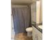 Bathroom with shower/tub combo and built-in shelving at 2447 W Emile Zola Ave, Phoenix, AZ 85029