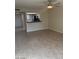 Living room with tile floors, a ceiling fan, and kitchen bar at 2447 W Emile Zola Ave, Phoenix, AZ 85029