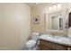 Well-maintained powder room featuring a toilet, sink, and decorative mirror at 25625 N Abajo Dr, Rio Verde, AZ 85263