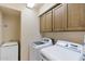 Functional laundry room with washer, dryer, utility sink, and lots of storage at 25625 N Abajo Dr, Rio Verde, AZ 85263