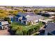 Gorgeous aerial view of a modern home with a pool, lush landscaping, and a well-manicured lawn at 2668 E Kingbird Ct, Gilbert, AZ 85297