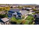 Expansive aerial view of a modern home with a pool, lush landscaping, and a well-manicured lawn at 2668 E Kingbird Ct, Gilbert, AZ 85297