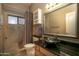 Bathroom featuring a vessel sink, granite countertop, decorative mirror, and walk-in shower at 3055 N Red Mtn # 156, Mesa, AZ 85207