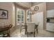 Bright dining area with shuttered windows and modern chandelier, adjacent to the kitchen at 3055 N Red Mtn # 156, Mesa, AZ 85207