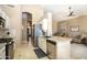 Well-lit kitchen featuring stainless steel appliances, center island, and tile backsplash at 3055 N Red Mtn # 156, Mesa, AZ 85207