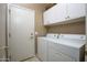 Practical laundry room featuring a washer, dryer, and overhead storage cabinets at 3055 N Red Mtn # 156, Mesa, AZ 85207