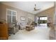 Inviting living room with vaulted ceilings, plantation shutters, neutral tones, and access to the patio at 3055 N Red Mtn # 156, Mesa, AZ 85207