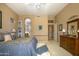 Another angle of the main bedroom with neutral decor, entry to bath, and furniture at 3055 N Red Mtn # 156, Mesa, AZ 85207