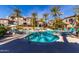 Community pool with lounge chairs and palm trees at 3236 E Chandler Blvd # 2053, Phoenix, AZ 85048