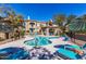 Community pool with lounge chairs and umbrellas at 3236 E Chandler Blvd # 2053, Phoenix, AZ 85048