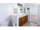 Double vanity bathroom with light brown cabinets and a large mirror at 3307 W Leodra Ln, Phoenix, AZ 85041