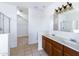 Main bathroom with double vanity, shower and separate tub at 3307 W Leodra Ln, Phoenix, AZ 85041