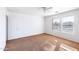 Well-lit bedroom with two windows and a ceiling fan at 3307 W Leodra Ln, Phoenix, AZ 85041