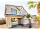 Two-story house with tan exterior, attached garage, and landscaping at 3307 W Leodra Ln, Phoenix, AZ 85041