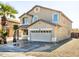 Two-story house with tan exterior, two-car garage, and desert landscaping at 3307 W Leodra Ln, Phoenix, AZ 85041