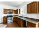 Kitchen with wood cabinets, stainless steel appliances, and tile floor at 3307 W Leodra Ln, Phoenix, AZ 85041