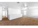 Spacious loft area with carpeted floor and ceiling fan at 3307 W Leodra Ln, Phoenix, AZ 85041