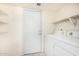 Laundry room with washer, dryer, and extra shelving at 3513 W Danbury Dr, Glendale, AZ 85308