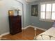 Bright bedroom featuring hardwood floors, fresh light-blue paint and a shuttered window at 3554 E Camino Cir, Mesa, AZ 85213