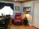 Relaxing red leather recliner and dark curtains fill this stylish bedroom at 3554 E Camino Cir, Mesa, AZ 85213