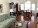 Bright dining room with hardwood floors and a formal dining set at 3554 E Camino Cir, Mesa, AZ 85213