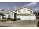 Charming two-story home with a three-car garage, desert landscaping, and an American flag at 3554 E Camino Cir, Mesa, AZ 85213