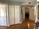 Bright hallway with hardwood floors and doors to bedrooms at 3554 E Camino Cir, Mesa, AZ 85213