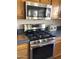 Stainless steel appliances and wood cabinets highlight this kitchen at 3554 E Camino Cir, Mesa, AZ 85213