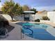 Inviting kidney-shaped pool with surrounding landscape at 3554 E Camino Cir, Mesa, AZ 85213