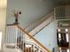 Bright staircase featuring a motorized stair chair and wood and white railings on blue walls at 3554 E Camino Cir, Mesa, AZ 85213