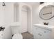 Updated bathroom with white vanity, modern fixtures, and a circular mirror at 4432 E Belleview St, Phoenix, AZ 85008