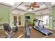 A well-equipped gym has various machines, a ceiling fan, and doors to an outside space at 5132 N 31St Way # 112, Phoenix, AZ 85016