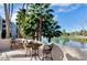 A spacious patio includes lake views with outdoor seating under a sunny sky at 5132 N 31St Way # 112, Phoenix, AZ 85016