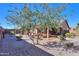 Landscaped backyard with mature trees and gravel at 5181 W Buckskin Dr, Eloy, AZ 85131