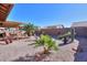 Landscaped backyard with covered patio and desert plants at 5181 W Buckskin Dr, Eloy, AZ 85131