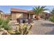 Desert landscaping with covered patio and fire pit area at 5181 W Buckskin Dr, Eloy, AZ 85131