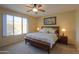 Bright bedroom with a king-size bed and large window at 5181 W Buckskin Dr, Eloy, AZ 85131