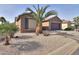 Charming one-story home with palm tree and gravel landscaping at 5181 W Buckskin Dr, Eloy, AZ 85131