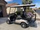 Tan four-passenger golf cart with upgraded wheels at 5181 W Buckskin Dr, Eloy, AZ 85131