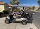 Tan golf cart with upgraded wheels and golf clubs at 5181 W Buckskin Dr, Eloy, AZ 85131