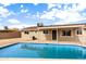 Backyard features a refreshing pool, desert landscaping and the rear of the single story home at 5313 W Osborn Rd, Phoenix, AZ 85031