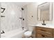 Modern bathroom featuring a tiled shower with niche, and a vanity with wood cabinet at 5313 W Osborn Rd, Phoenix, AZ 85031