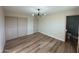 Well-lit bedroom with hardwood floors and mirrored closet doors at 5313 W Osborn Rd, Phoenix, AZ 85031