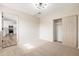 Bedroom with neutral carpet, sliding closet doors, and access to the kitchen at 5313 W Osborn Rd, Phoenix, AZ 85031