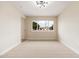 Bright bedroom with carpet flooring, a window with neighborhood view, and neutral color palette at 5313 W Osborn Rd, Phoenix, AZ 85031