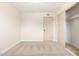 Bedroom features carpet, modern lighting, and a closet with sliding doors at 5313 W Osborn Rd, Phoenix, AZ 85031