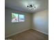 Well-lit bedroom with large window and neutral walls at 5313 W Osborn Rd, Phoenix, AZ 85031