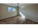 Spacious bedroom with hardwood floors and large window providing ample light at 5313 W Osborn Rd, Phoenix, AZ 85031