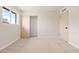 Bedroom featuring neutral carpet, light walls, closet with sliding doors, and a window at 5313 W Osborn Rd, Phoenix, AZ 85031