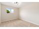 Bedroom with neutral carpet, a modern light fixture, and a view of the neighborhood at 5313 W Osborn Rd, Phoenix, AZ 85031